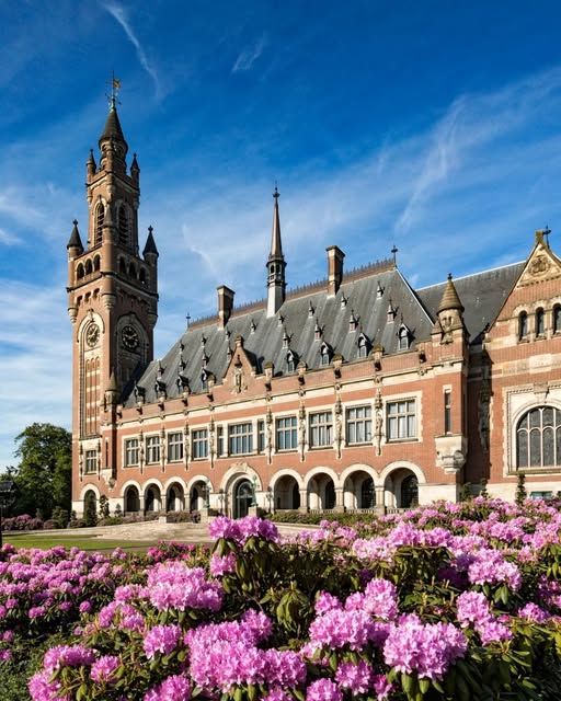 Picturesque canal in Delft, Netherlands with boats and autumn trees